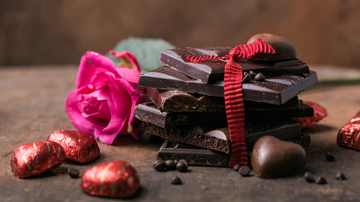 Chocolate with ribbon, rose and heart on It.